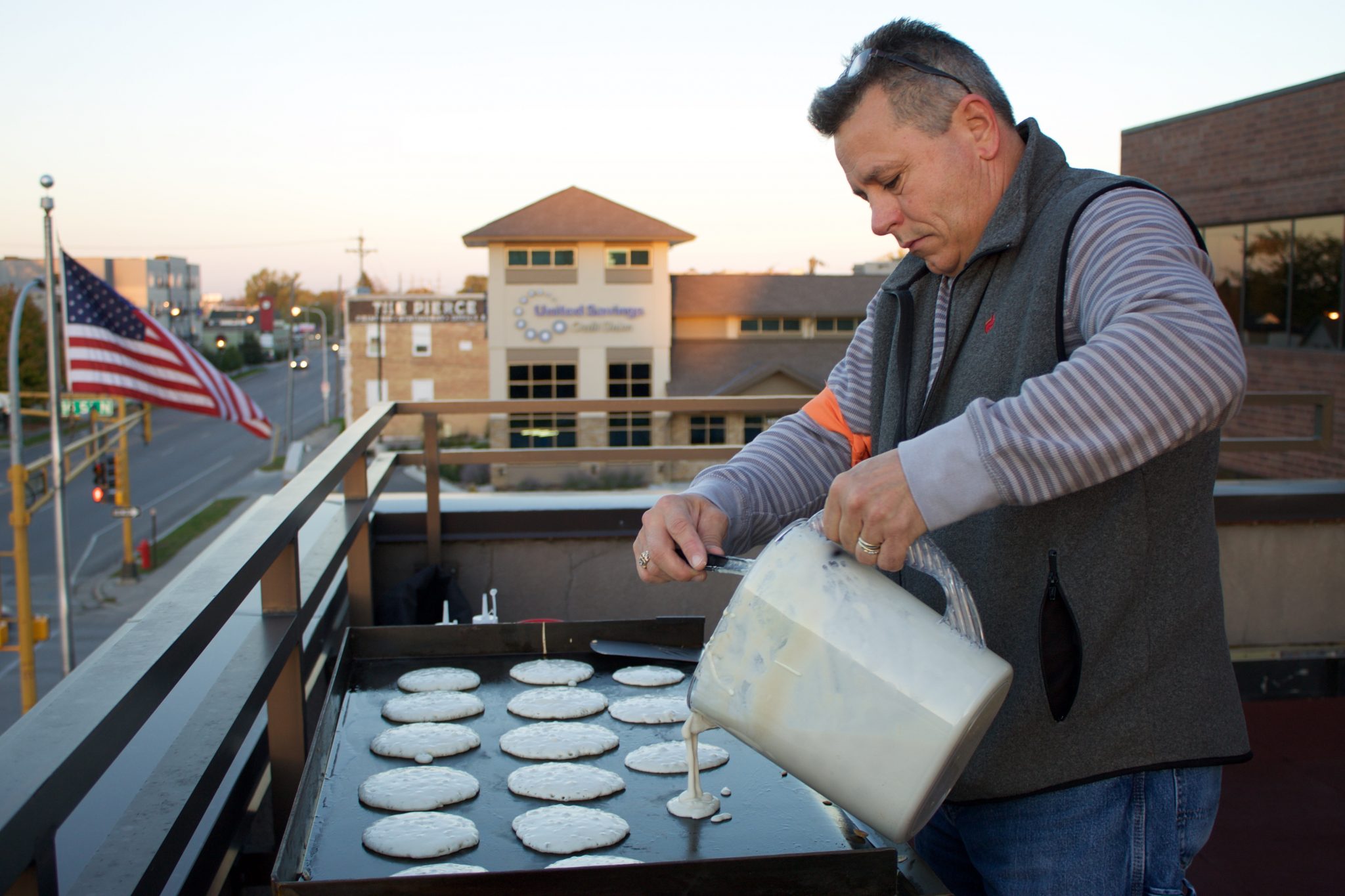 Jeff Reed makes pancakes on the balcony at Flint 